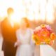 Newlyweds with the bride's gorgeous bouquet enjoying sunset together